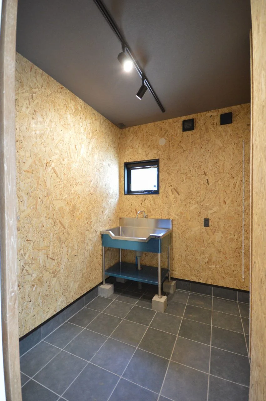 【趣味室】 海釣りが趣味で、自分で魚を捌くためのシンクを設けた趣味室。 後でいろいろ設置できるように内装はOSB合板で。